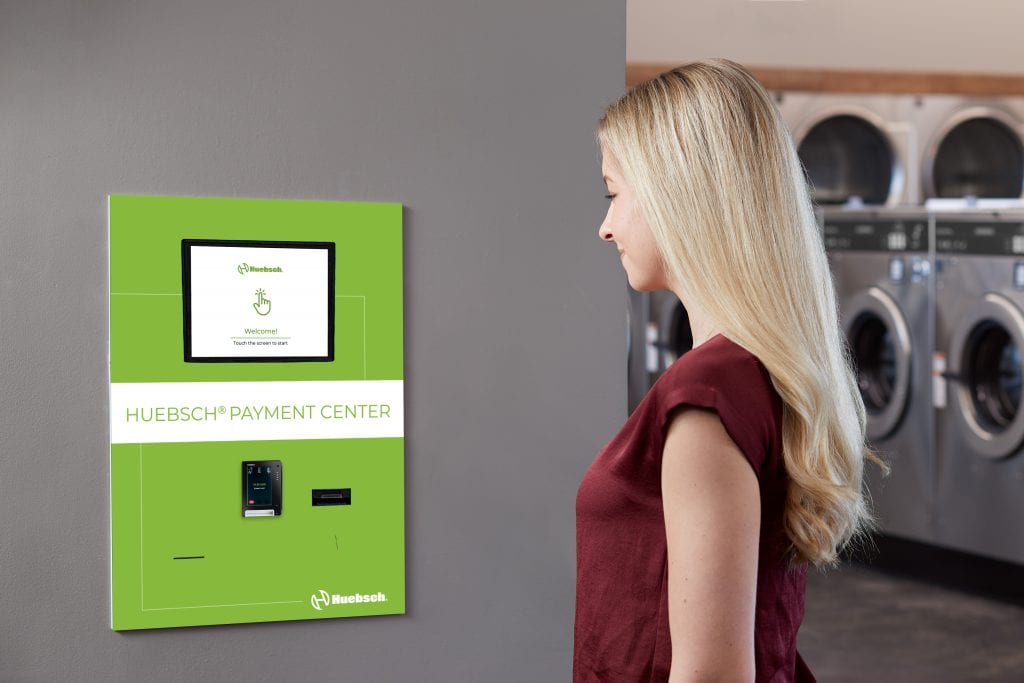 woman looking at a Huebsch payment center screen