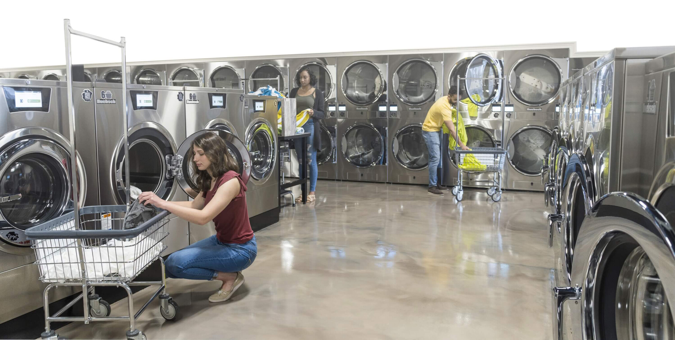 StressFree BKGD interior of Huebsch laundromat with guests doing laundry