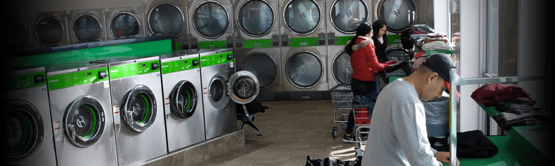 three people in laundromat