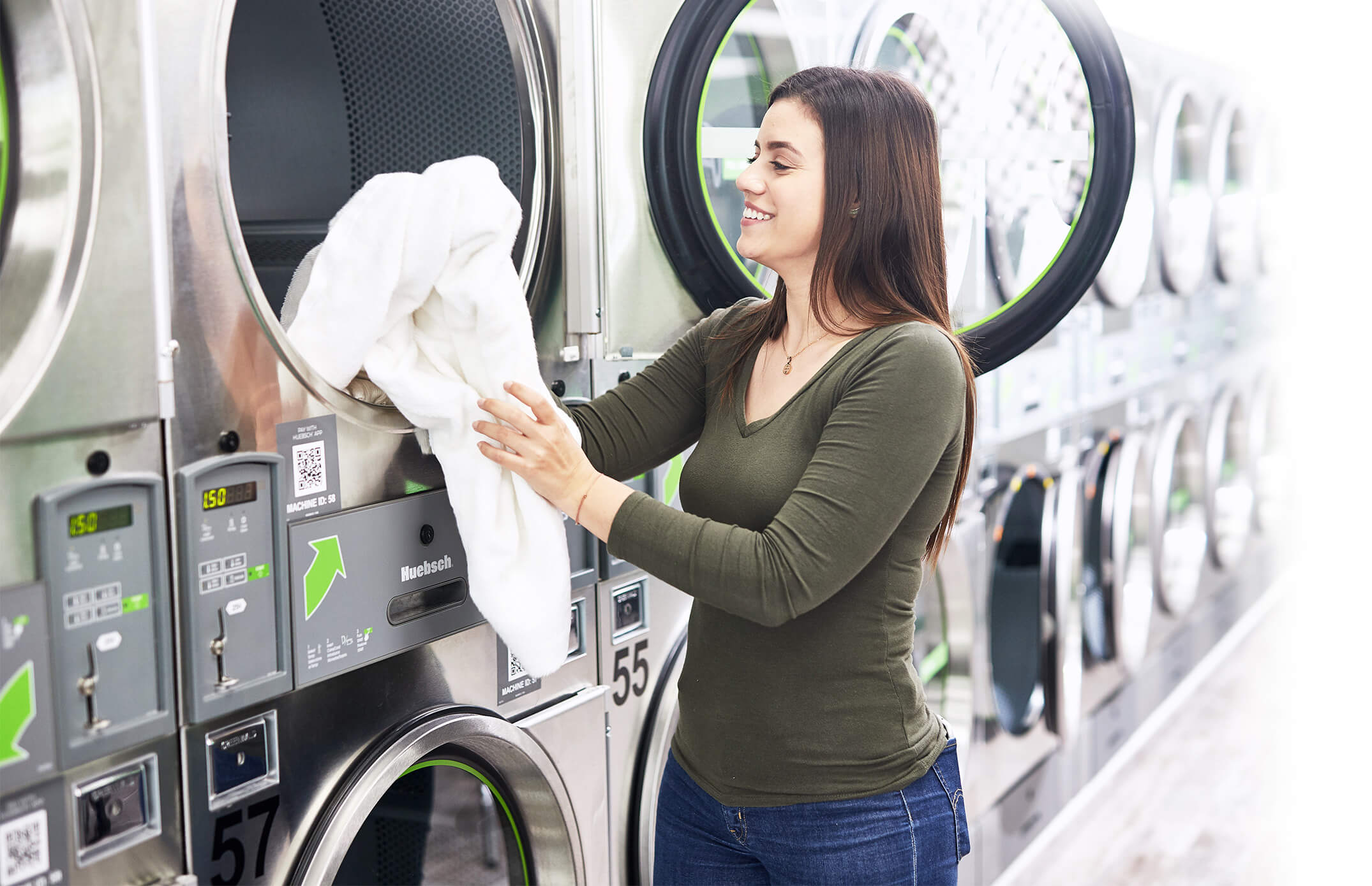 woman pulling towel out of dryer
