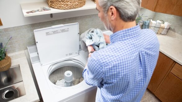 apartment owner standing at laundry machine