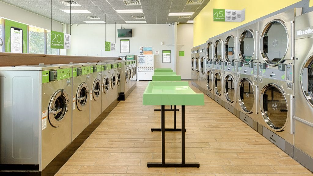 Huebsch laundromat with green folding table
