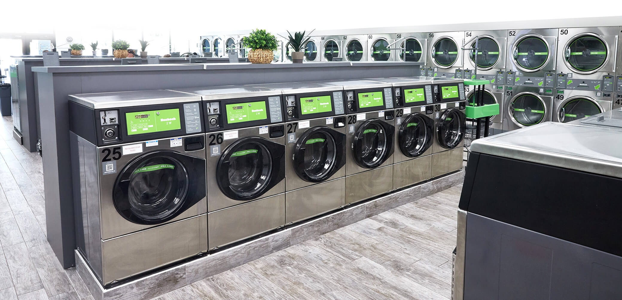 row of washing machines in laundromat