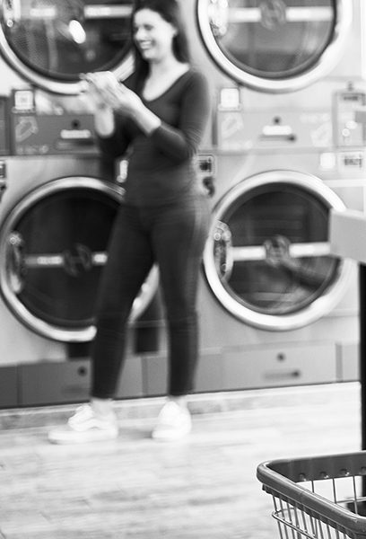 woman smiling at a laundromat