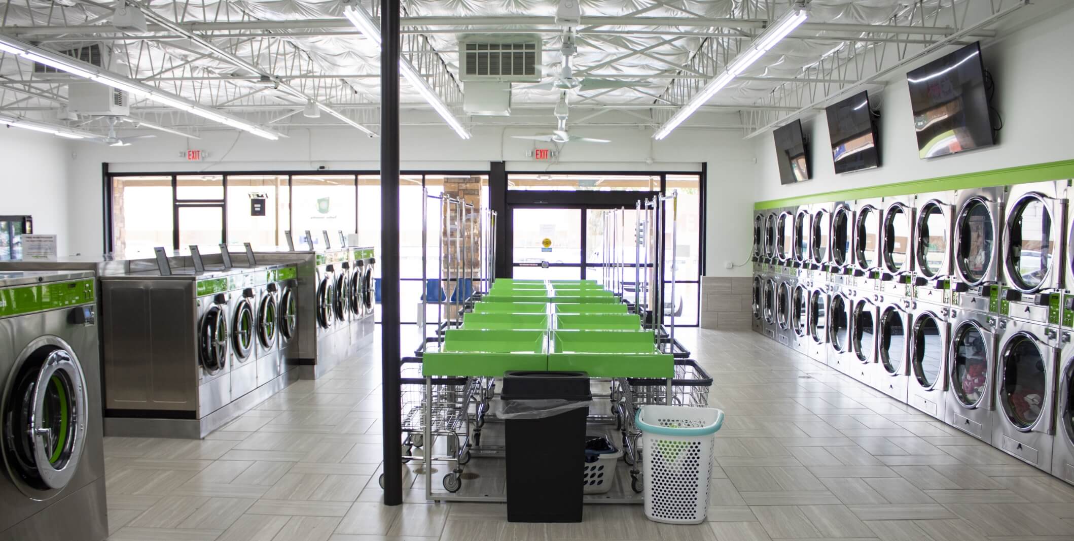 inside laundromat with green folding table